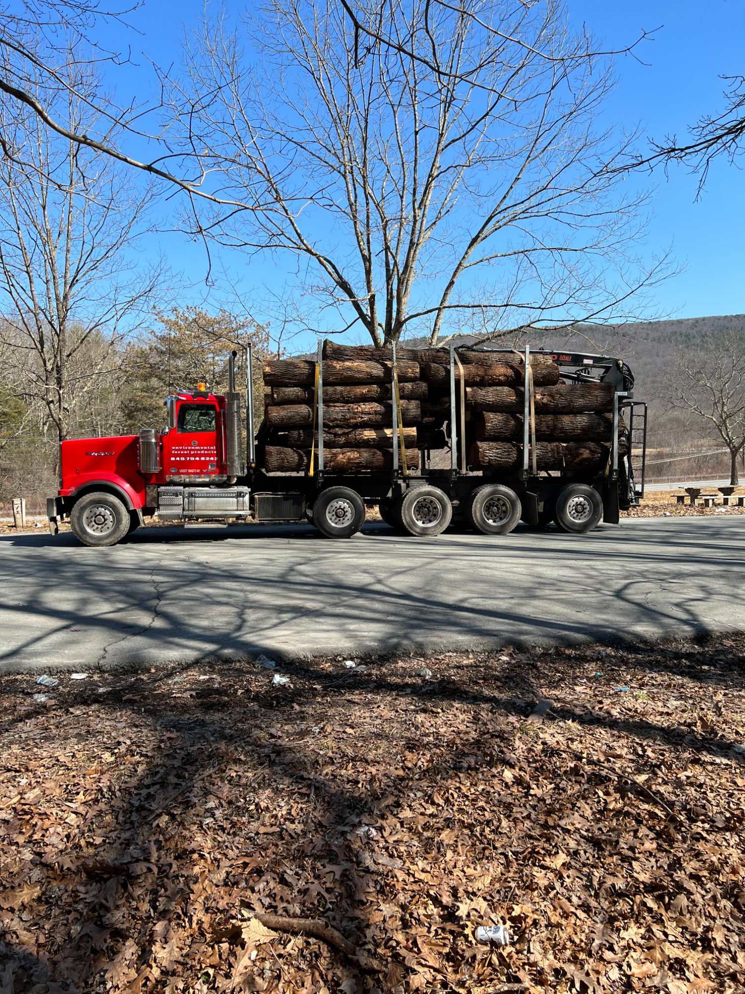 Environmental Forest Products log truck loaded with hardwood timber leaving a project in Sparta, NJ